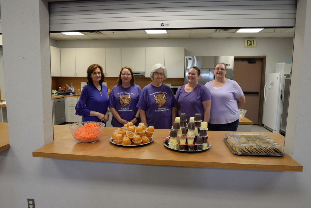 Community volunteers pose with snack