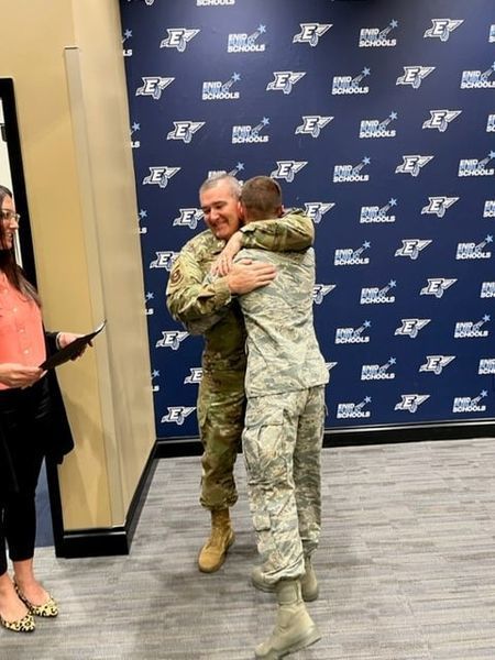 Student and commanding officer hug