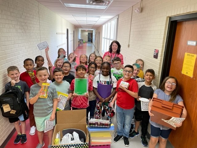 Ms. Purdy's class holding school supplies